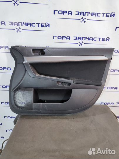 Обшивка двери передней правой Mitsubishi Lancer