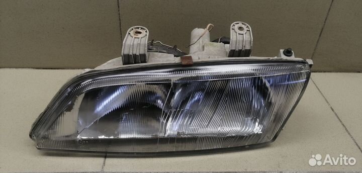 Фара левая Primera P11E 1996-2002