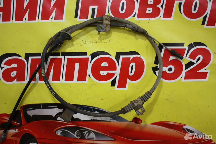 Трос стояночного тормоза левый Mitsubishi Outlande