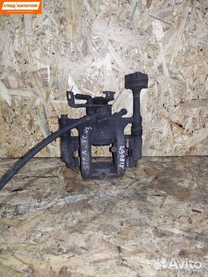 Суппорт тормозной задний левый Opel Astra J