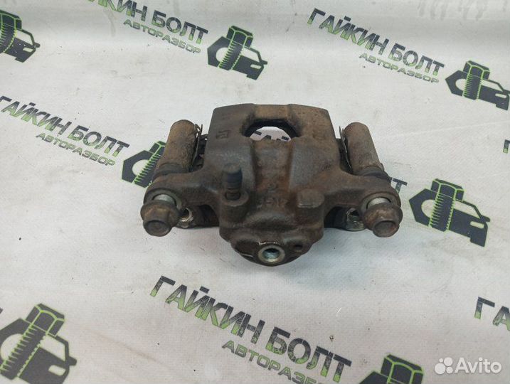 Суппорт тормозной задний левый Nissan Qashqai J10