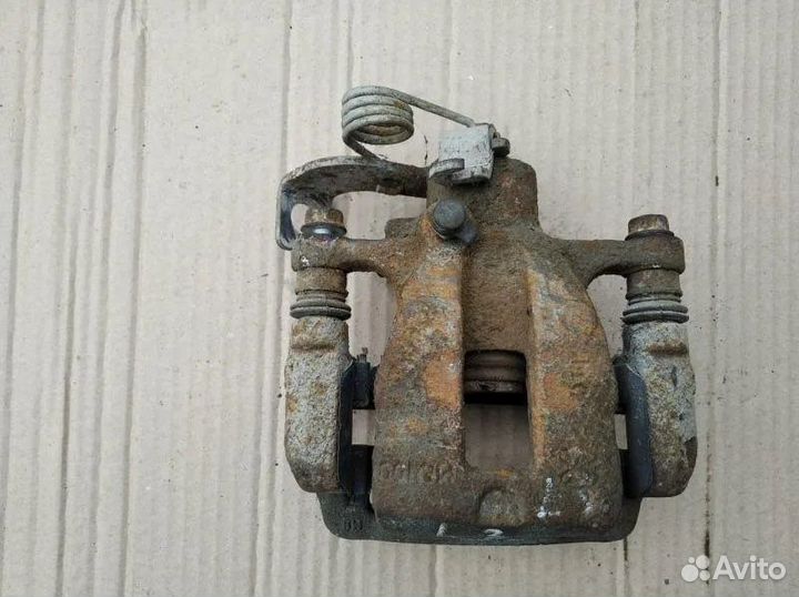 Суппорт тормозной задний kia rio 3 левый